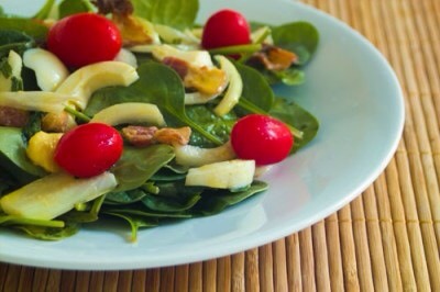 Warm Spinach Salad

Eggs, bacon, onion, and tomatos unite to make this delicious spinach salad. The secret is in the dressing ... that's right, there's extra bacon drippings in there for a little extra indulgence.
