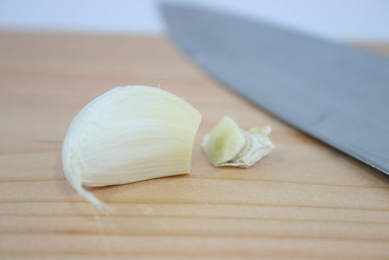 Mash up one garlic clove. Put all the ingredients together. It sould be in a tiny oil fragrance bottle (make sure the scent from the original oil is gone. You dont want the harsh chemicals to mix and damage your nails) or a container. Whatever you could find. Garlic is ideal for growing nails& hair.