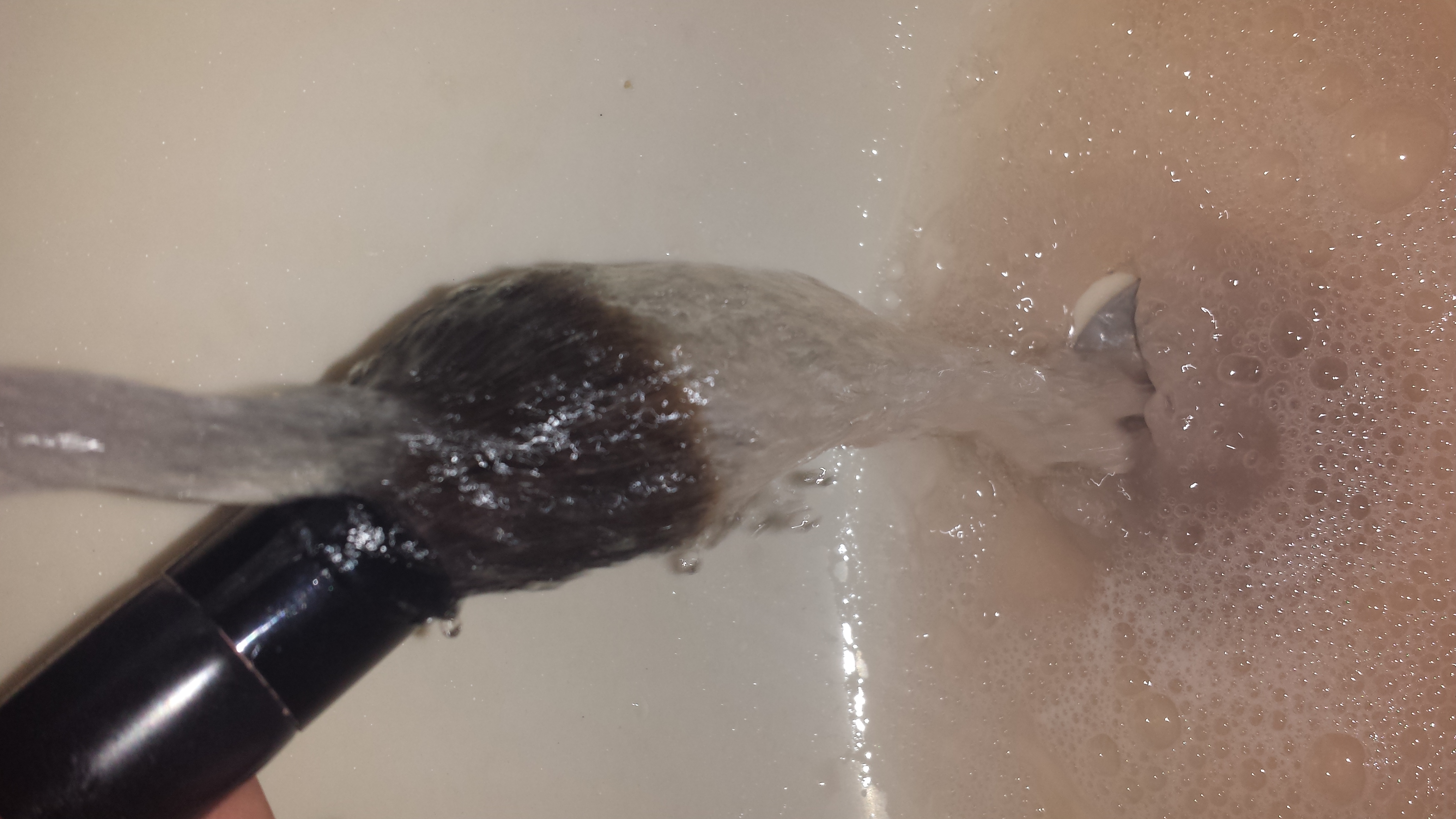 Rinse your brush again facing down until you remove all of the dish soap and oil 