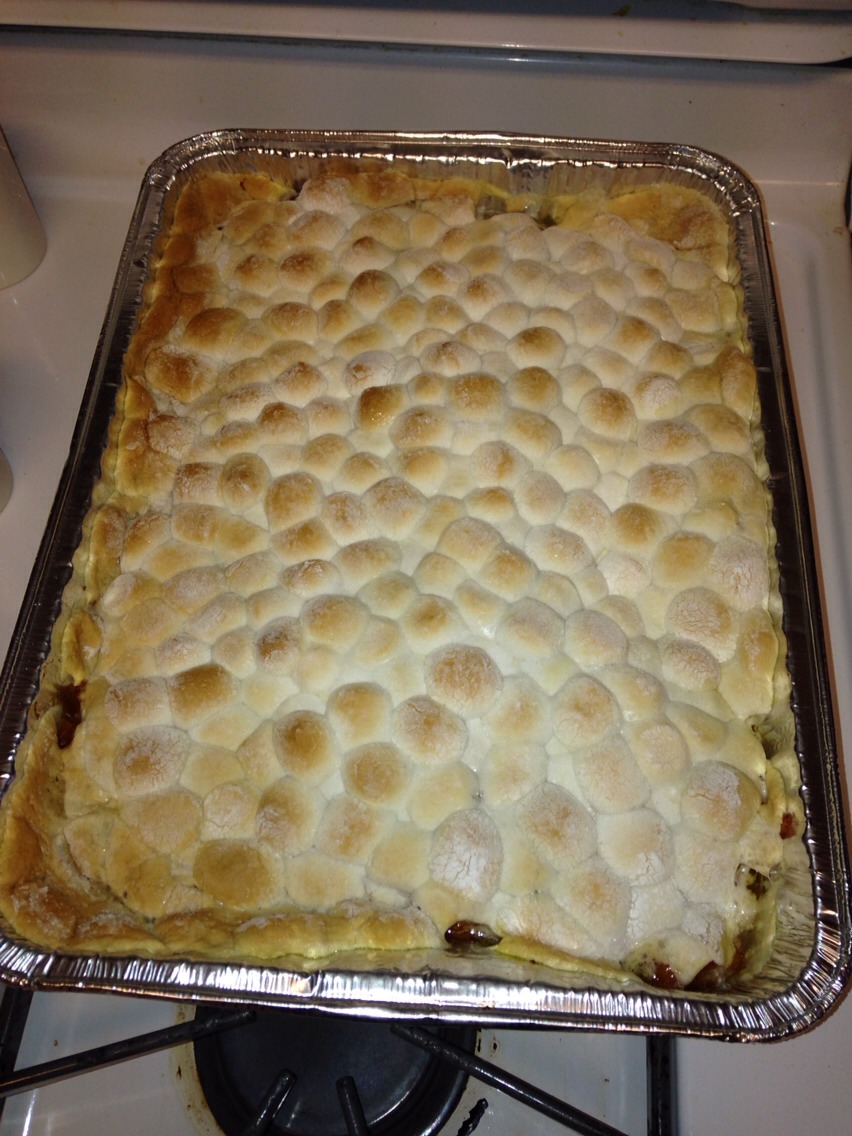 Bake in preheated oven for 15 minutes. Remove from oven and cover top evenly with remaining marshmallows. Return to oven and bake until marshmallows are golden brown