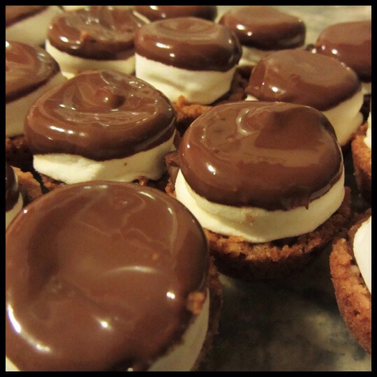 Step 5:
Break remaining candy bars and place in bowl. Microwave on HIGH 1 minute-1 1/2 minutes or until melted and smooth, stirring every 20 seconds. Dip the top of each marshmallow in melted chocolate. Turn top-side up and let stand 40 minutes-1 hour or until set.