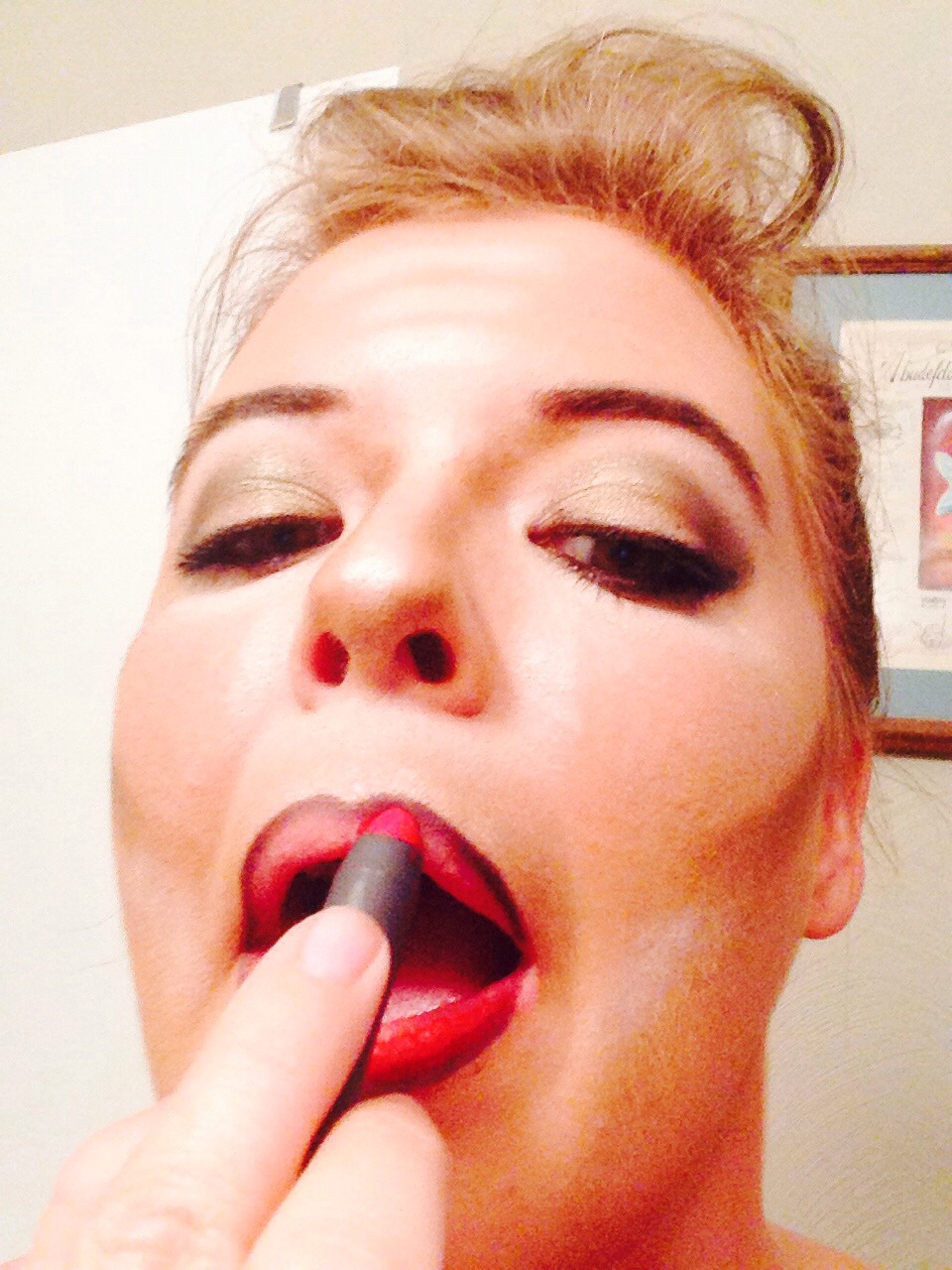 Fill lips in with a red lipstick. I used a Pomegranate lip pencil by Bite Beauty. 