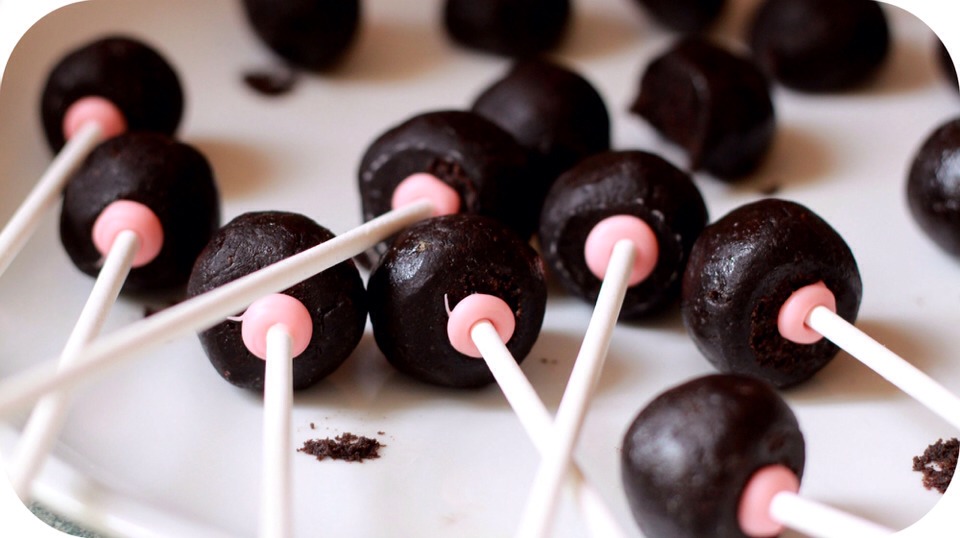 Afterwards, take some melted chocolate or candy melts and melt them. Dip a cake pop stick into the chocolate and insert it into the Oreo pop; this creates a seal preventing the stick from pulling/falling out. Allow the chocolate to set before decorating.