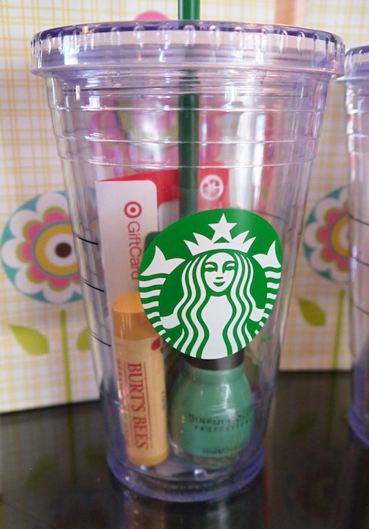 9. Gift In A Cup
Who couldn’t use an on-the-go insulated cup?! Fill it up with some of their favorite goodies (gift cards, drink packets, lip gloss, nail polish, candy, or anything else that will fit) and you’ve got a gift that works for just about anyone!