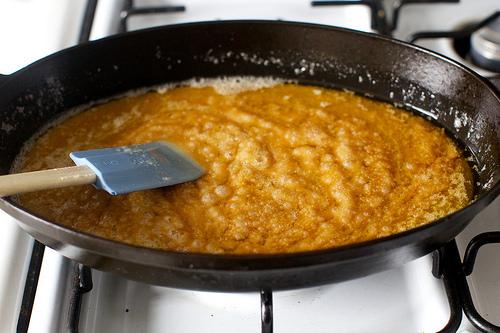 The butter will melt and, after 7 to 10 minutes, the sugar will dissolve and begin to brown.

Reduce heat to medium-low and stir with a spoon or spatula so that it browns evenly. You will find that the butter separates from the melting sugar and this is just fine. 