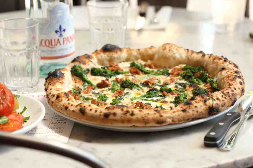 
8. Sausage-Broccoli Rabe Make New York-Style Pizza with only 1 1/2 cups mozzarella. Add 2 crumbled raw sausages. Bake until just crisp, then top with 4 ounces bocconcini, sauteed broccoli rabe and jarred cherry peppers. Bake until the cheese melts.