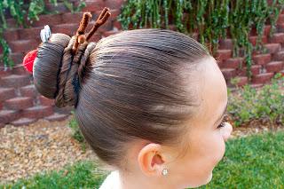 Pull the bun mold or sock over your ponytail and then spread the hair evenly over the mold.  Grab a second elastic and secure it over the top of the hair and the mold. 