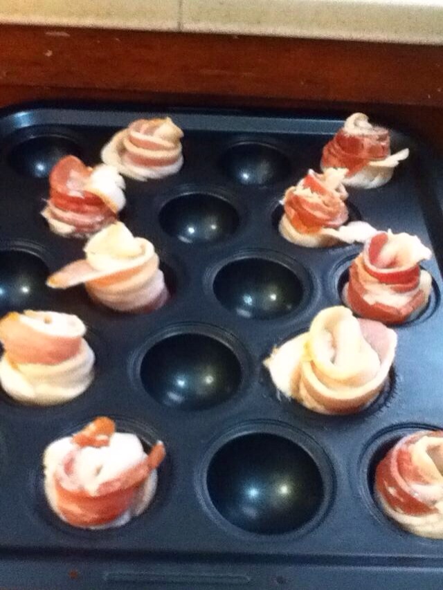 -> Preheat oven to 375 F.
-> Roll bacon strip up and place into muffin pan. 
-> Repeat with all bacon strips.
-> Bake for 10 minutes. 