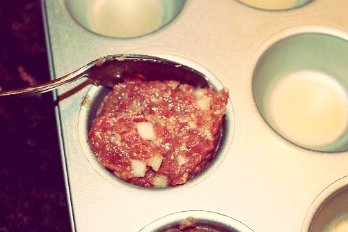 Spoon into muffin pan. Use the back of the spoon to make an indentation.
Then spoon in spaghetti sauce.
Bake for 30-45 minutes at 375°