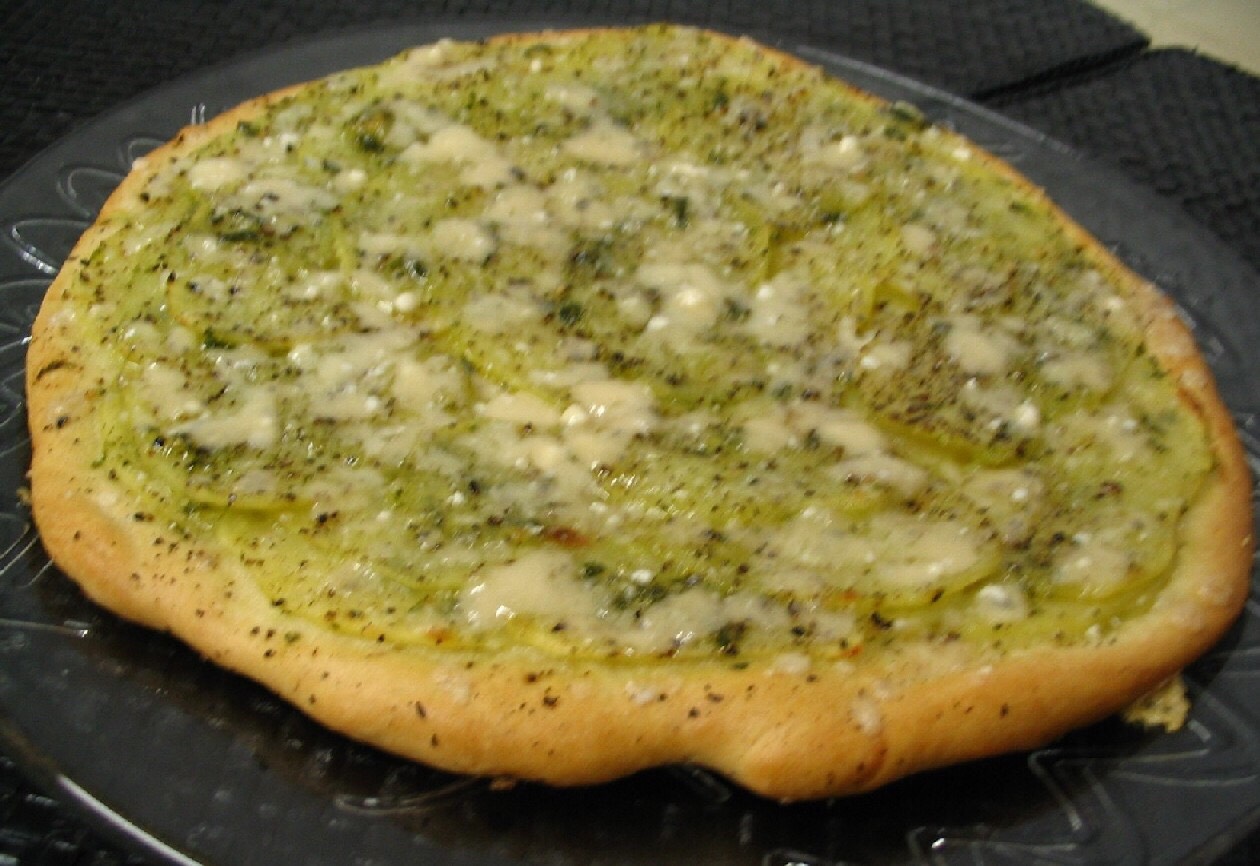 27. Verde Stretch dough into a 15-inch round; bake until crisp. Puree 1/4 cup each pistachios, basil, parsley and scallions with 1 cup arugula, 2 garlic cloves, 1/2 cup olive oil, salt and pepper. Spread over crust. Top with Parmesan and more arugula.