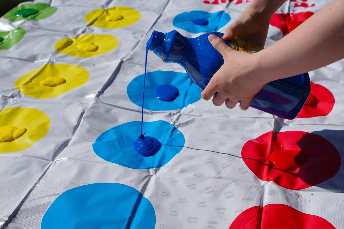 play messy twister! put paint or colored shaving cream on each spot for a fun twist on the classic twister game!
