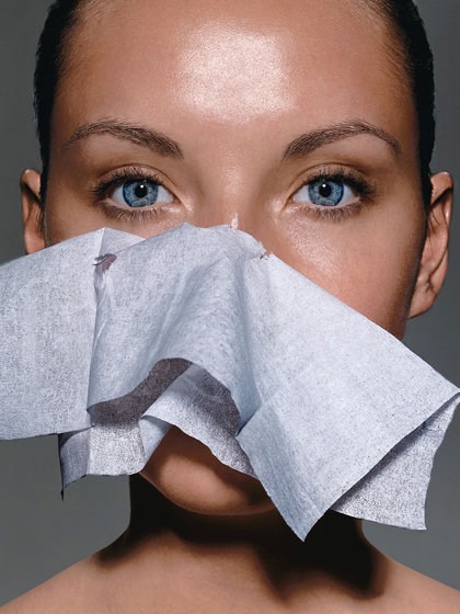 Use blotting sheets they do not take of your makeup but they do absorb oil.