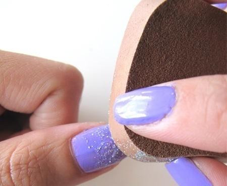 4. Gently dab the glitter sponge onto the upper half of your nail to create a gradient effect.