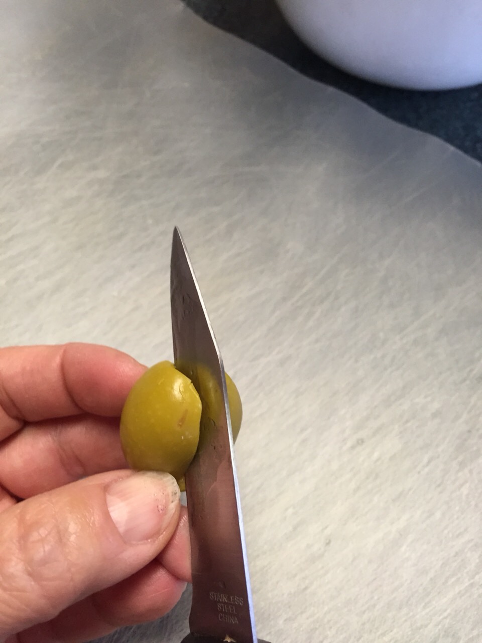 Slit from top to bottom...do NOT cut olives in half. 