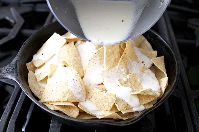 Next, drizzle the garlic cream sauce all over the chips.