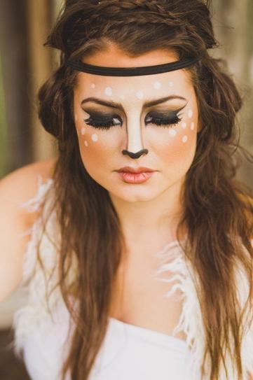 23. Make your eyes emphasized by going for smudged eyeliner and wearing false lashes. Create vertical lines on your nose with black pencil and join them at the end. Apply peachy blush and create white dots on your cheeks.