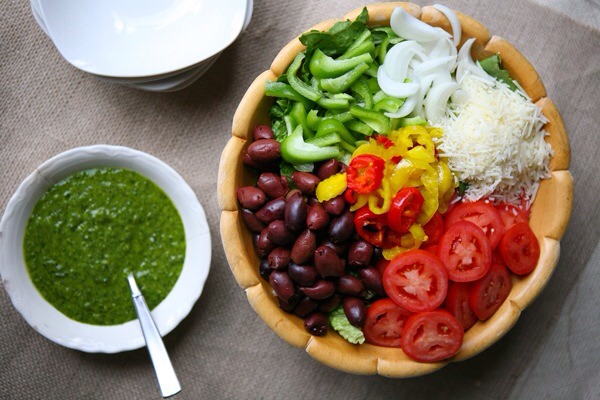Italian Salad and Fresh Basil Vinaigrette

This lettuce-less Italian salad is full of olives, tomato, peppers, and onions and topped with a vibrant green basil dressing. Molto bene!
