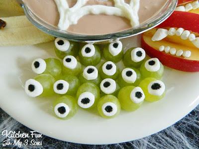To make the Monster Eye Balls you want to cut the grapes in half. Cut the mini marshmallows in half as well. Press the black edible marker in the middle of the marshmallow then place them on top of the grapes (they will stick).