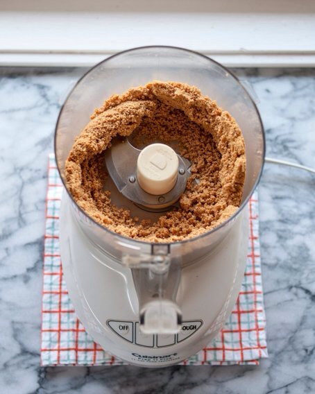 Keep running the processor or blender for another minute. Stop and scrap down the sides and bottom, the peanuts should look dry and gritty.