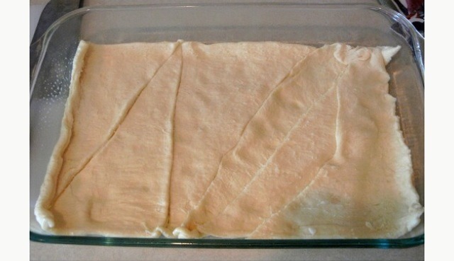 Fry up bacon and place on paper towel to drain.
Roll out crescent roll dough into greased casserole dish. 
