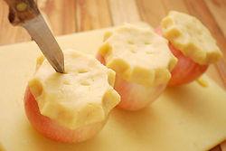 Gently lay the crust circles over the apple tops and pinch the edges together much like you would a regular pie to seal the edges. Poke four little holes in the top to allow steam to come through.