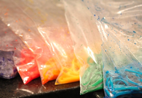 Add about 20 drops of food coloring and 2 tablespoons water to each bag. Then once the pasta is done, drain it and then immediately run cold water over it in a strainer or colander to halt the cooking.

Transfer the pasta, portioning it as you go, into the bags of food coloring. 