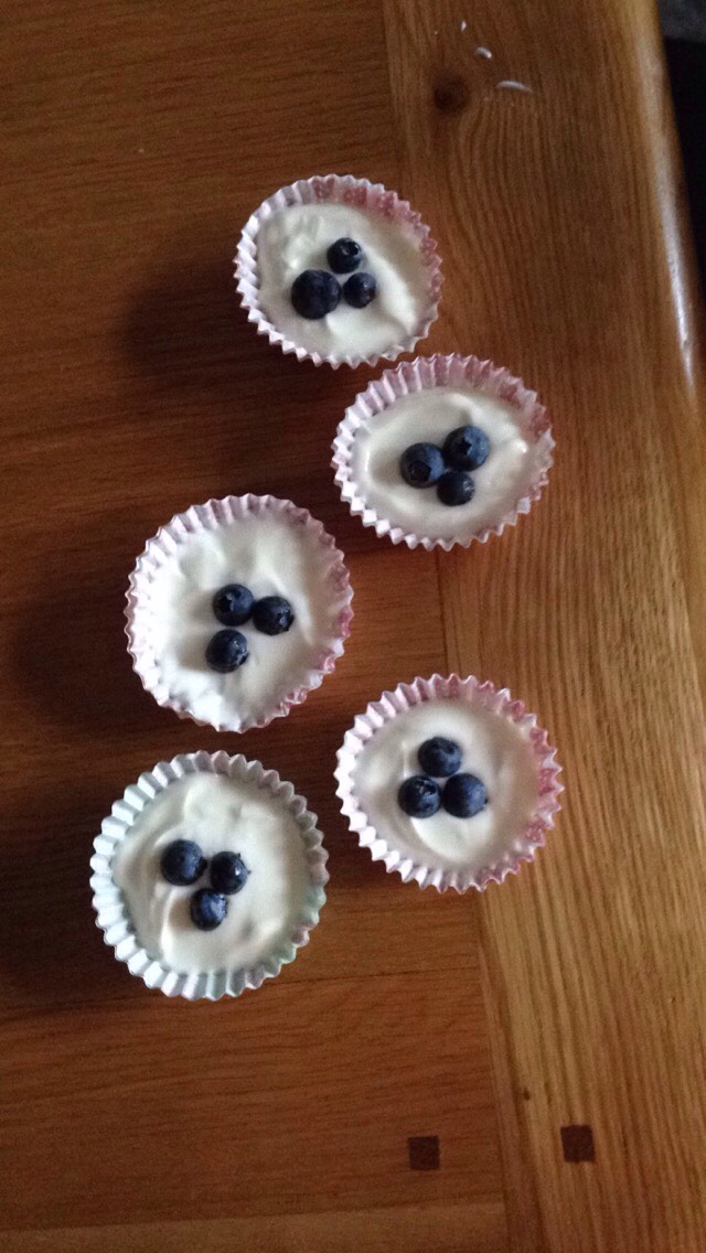 Gentle press 3 blueberries into the yogurt (any fruit will do) 