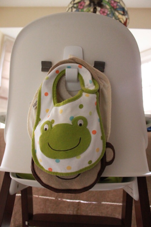 17. Stick a Command hook on the back of a high chair to hold bibs.