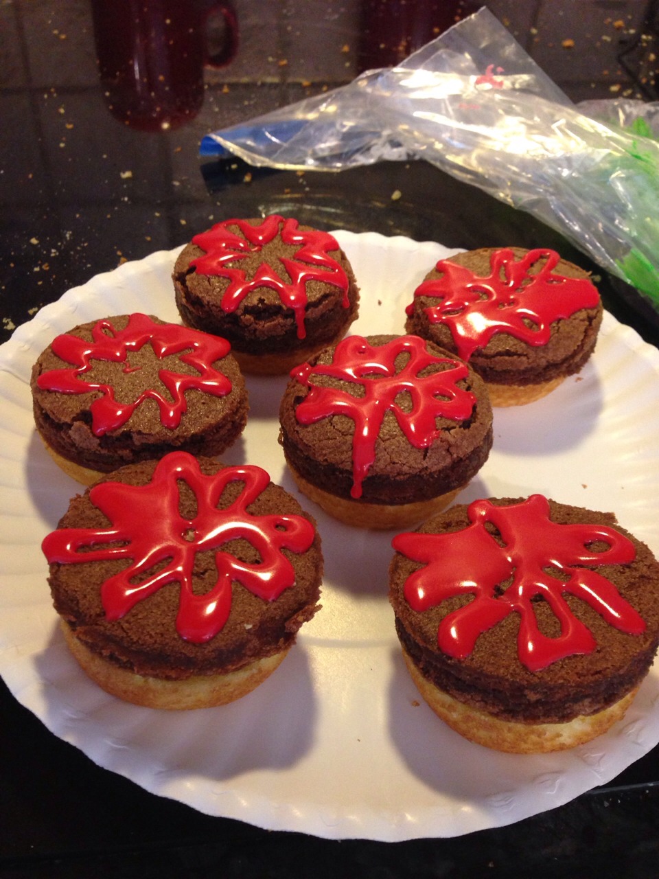 1.Bake the cupcakes in non stick muffin tins(only fill about 1/2 of the well)  
2.Spread out the brownie batter to about 1/2-3/4 of an inch
3.When cooled, carefully cut the cupcakes in half 
4.Use a round cookie cutter to cut out the brownie patties 
5.Use red, green and yellow icing to decorate