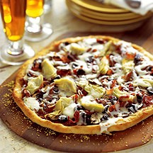 3. Quattro Stagioni Make Margherita Pizzas (No. 1); before adding cheese, top with olives, artichoke hearts, ham and sauteed mushrooms in 4 sections.