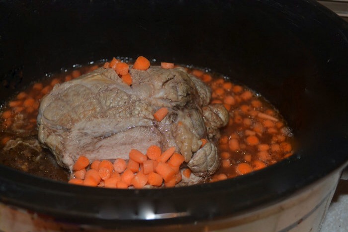 2) Cook for several hours.  When you see the pork starting to ” pull apart” cut the rope off and shred meat.  You will want to add the shredded zucchini and chopped carrots at this time. 