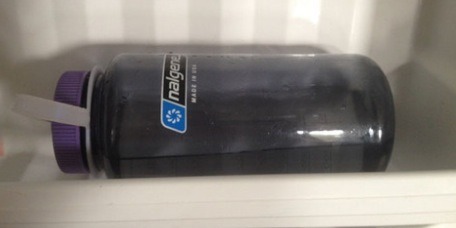 Fill up half your water bottle but not so much that it goes above the cap when on it side. This way u can get the cap open and be able to drink the water!
