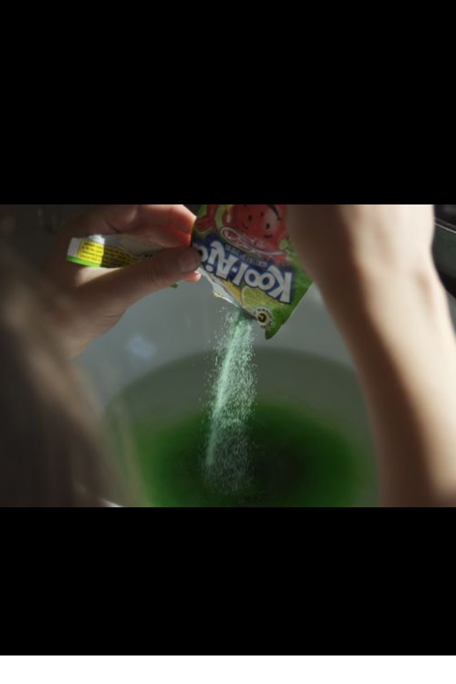 Pour the kool aid into the water and stir 