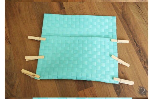 Next fold placemat over while leaving about a 4 inch top to fold over the top of the opening of your clutch. After this glue the sides together and keep it down by putting clothes pins along the sides. Keep pins on until the glue drys and then remove pins. 