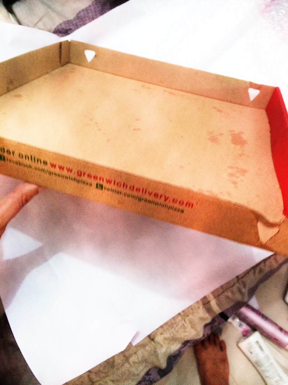First, you need to cut the other side of a pizza box. Be sure it's clean before wrapping it.