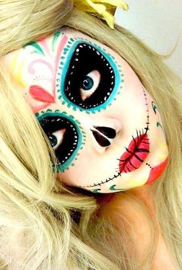 9.Look eccentric, going for another ultimately cool Halloween makeup idea and apply black shadow over your eyes and finish the circle with blue shadow and green spots. Draw flowers on your forehead and chin. The red lipstick will complete your Halloween makeup.