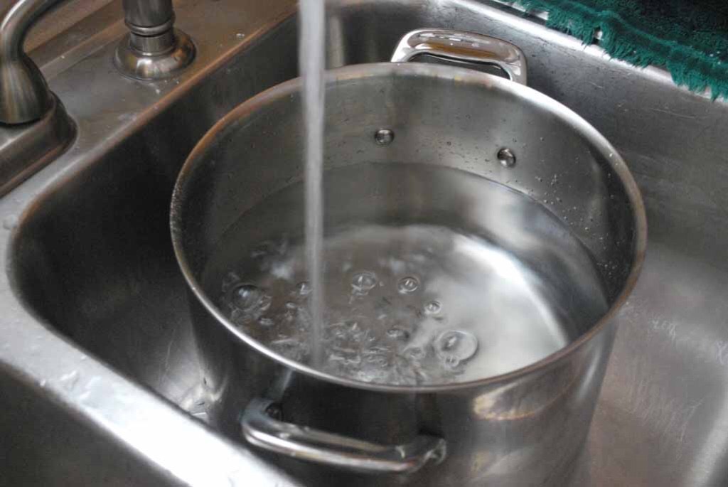 First you fill your pot, about half way. Then place it on the stove.