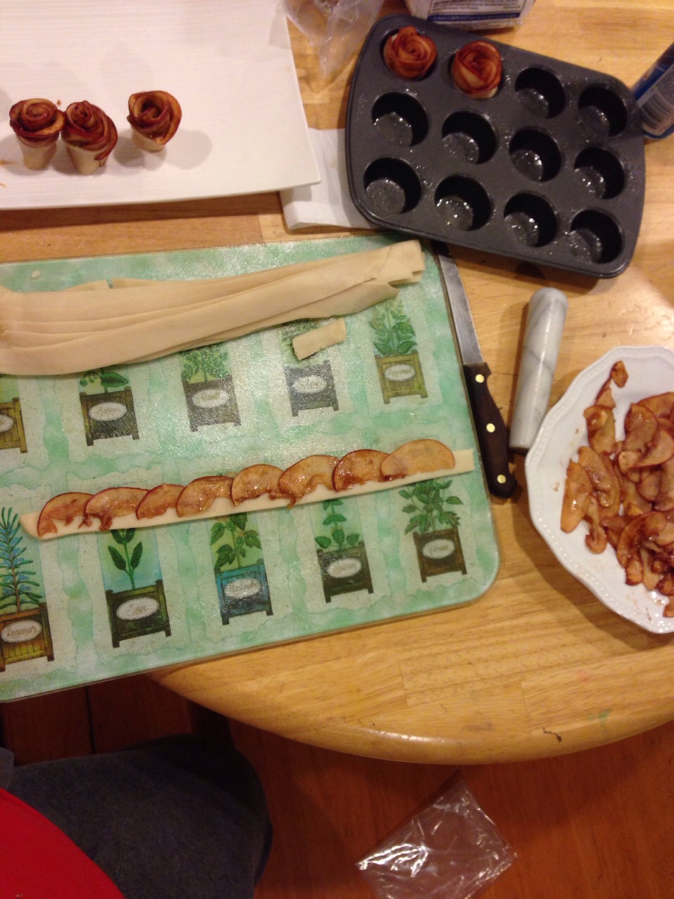 Place the apple slices on the dough with about half of the slice on the dough and half above it.
Layering the slices like so.