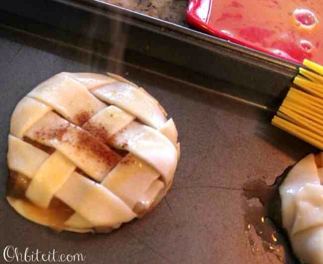 👈👈Dip your cookie cutter into some egg wash and cut out your Pie Cookies


Brush the tops of them with some egg wash and sprinkle them with the Cinnamon Sugar and Nutmeg..


