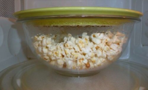 Reduce unpopped kernels by cooking popcorn in a bowl topped with a plate.