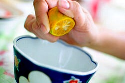 Using a fresh lemon, squeeze a small amount of lemon juice into a container. One to one-half teaspoons should suffice.