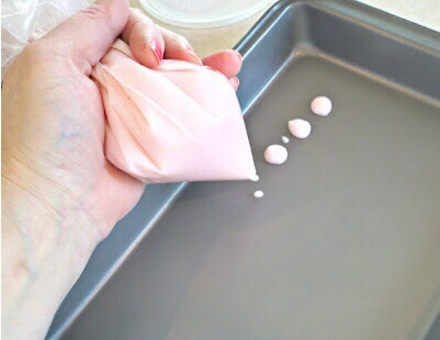 Spoon your yogurt into a Ziploc bag and seal it closed. Cut a small corner off of the tip so it becomes a piping bag. Take a baking sheet or plate and squirt little drops of the yogurt on it.