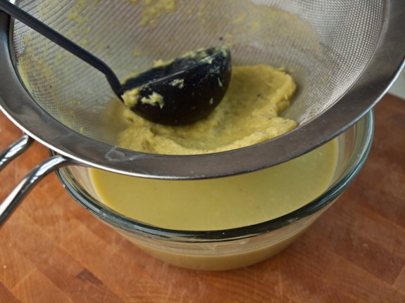 I like to pass the soup through a fine sieve because asparagus is very fibrous. If you use a standard blender to purée the soup, this may not be necessary, but my immersion blender leaves too many fibers behind. It only takes a few minutes and makes a big difference in the end result.