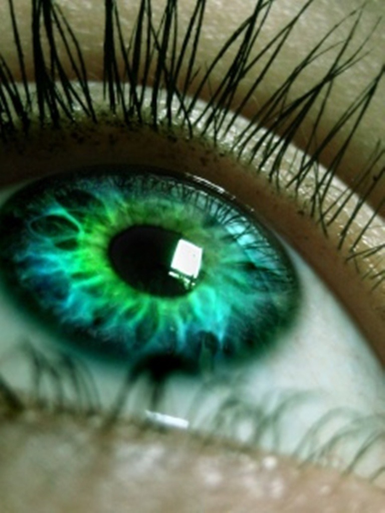Neither blue nor green pigments are ever present in the human iris. Eye color is therefore something like the sky, it depends on the lighting conditions, especially for lighter-colored eyes.