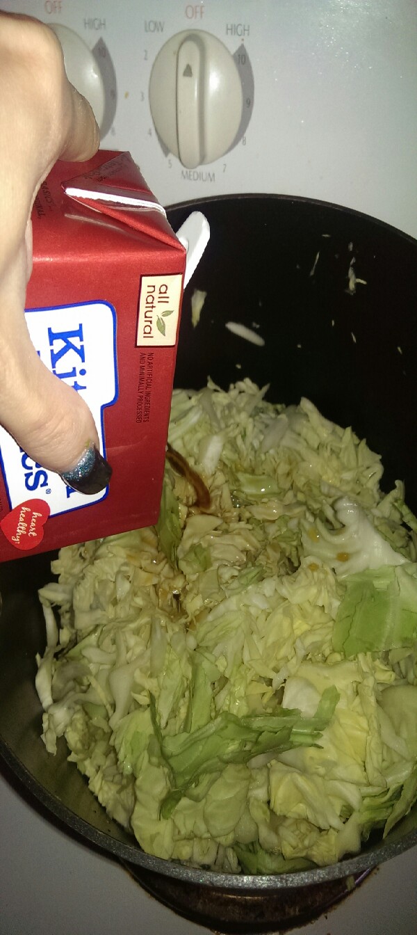shred cabbage and pour in beef stock and turn on to high heat I also add 2 tablespoons of the garlic and herb seasoning 