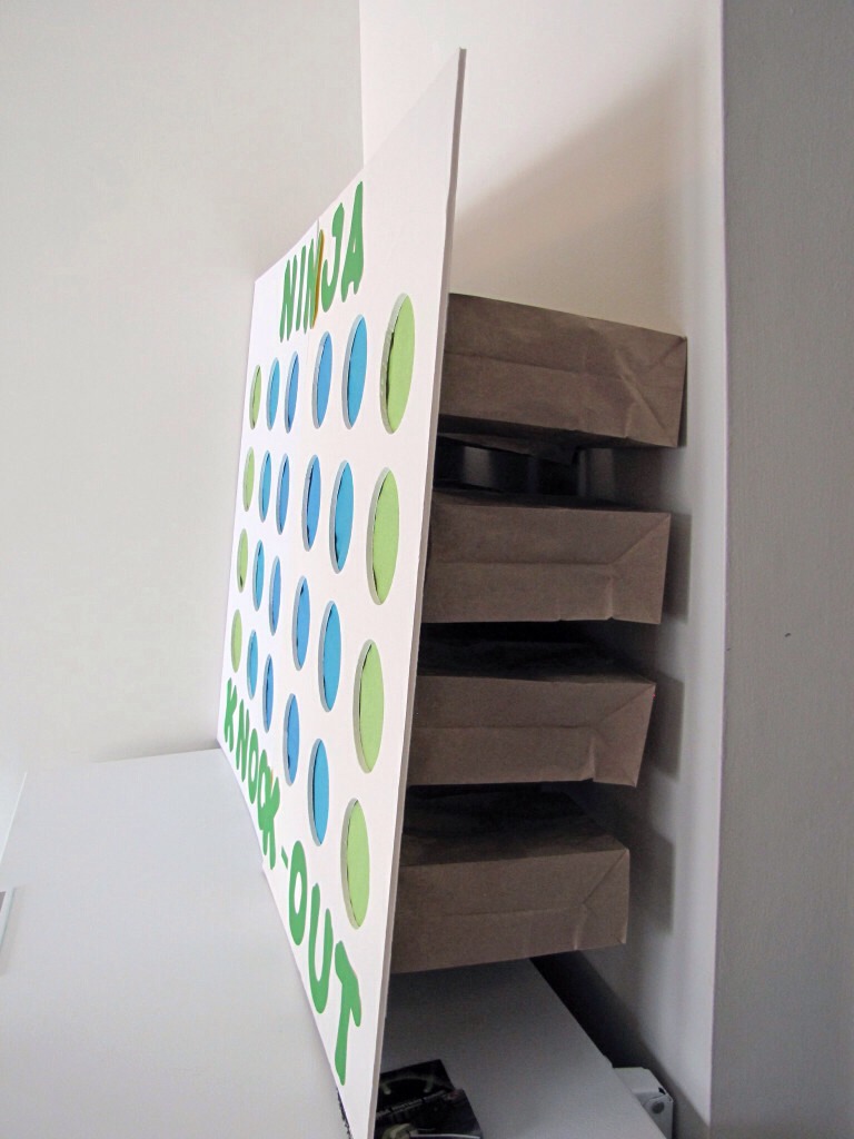 It consists of a foam core board with circles cut out. Tissue paper is taped to the back side and paper bags filled with things such as tmnt themed candy, comic books, or 1 luck person can win an advanced ticket to the show. 