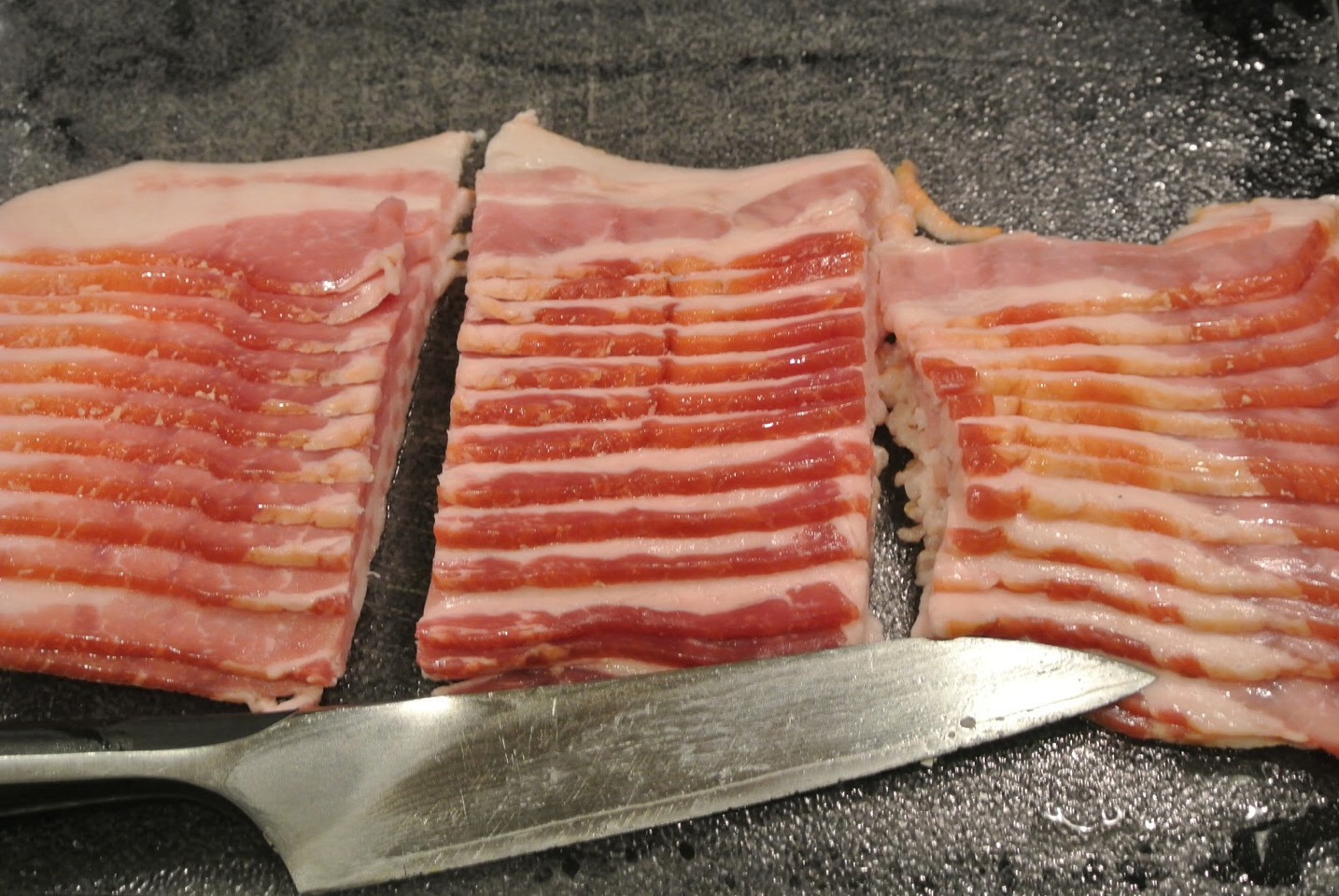 3. Cut bacon into thirds or halves enough to fully wrap around chicken. If you have toothpicks you can use smaller pieces of bacon. If you don't use larger pieces and completely wrap bacon around itself. 