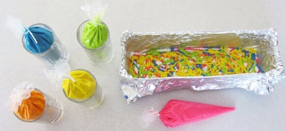 Put cake batter into baggies and snip the tips off of them, start filling your pan with the batter and swirling the colors as shown