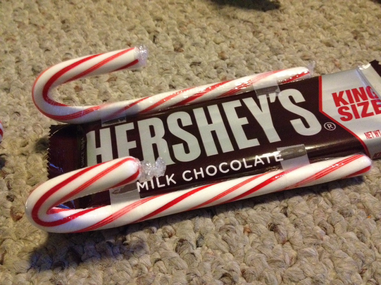 Tape on the two candy canes to each side 