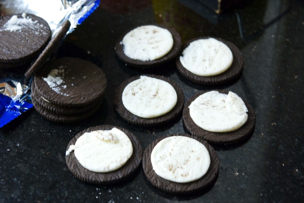 3. Get chocolate Oreos. Split them apart with all the white on one side.  You will need 2 for each cupcake. 